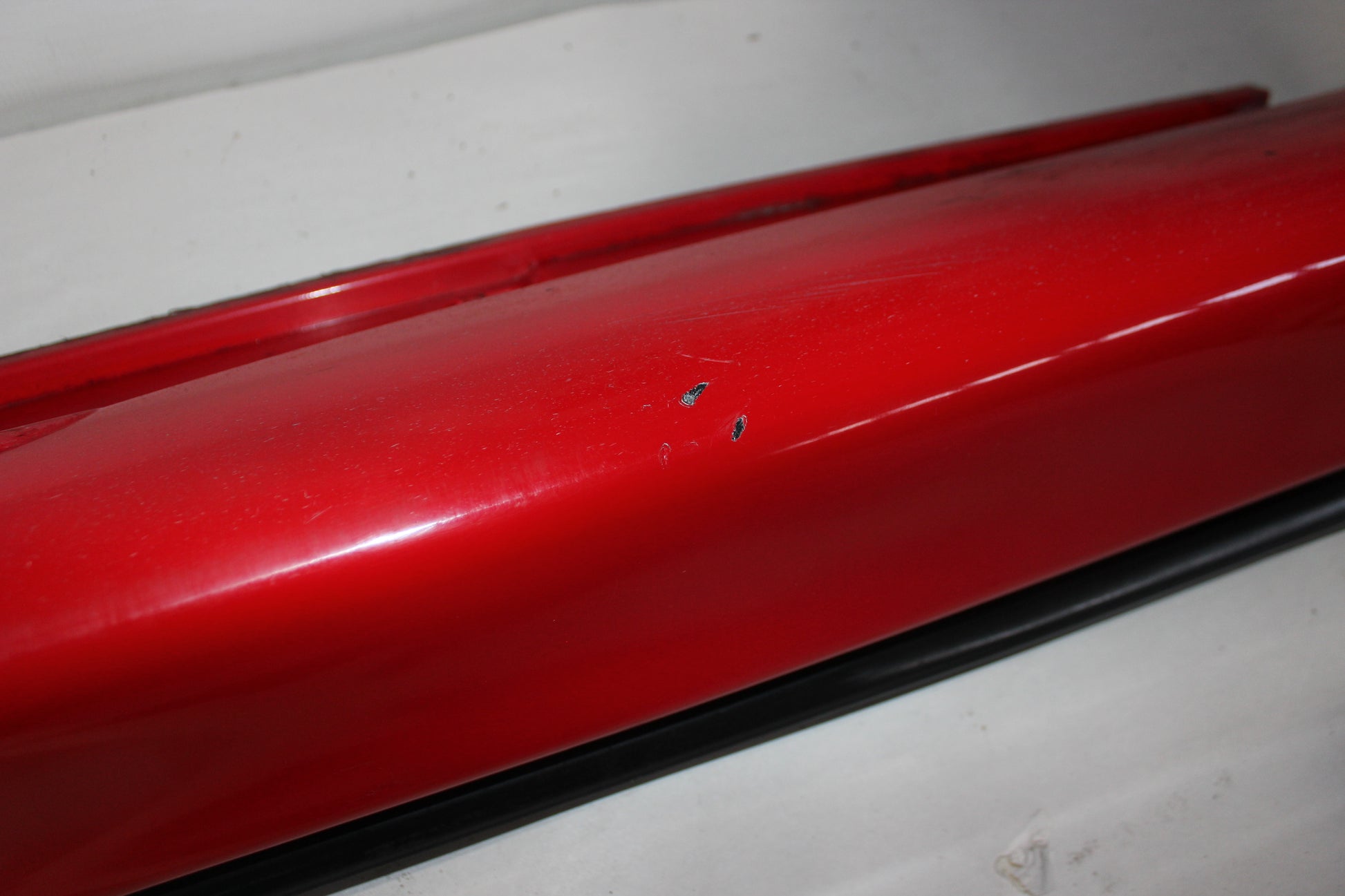 2006 Pontiac GTO LH Driver Rocker Molding Panel Red OEM - Day's Parts Yard