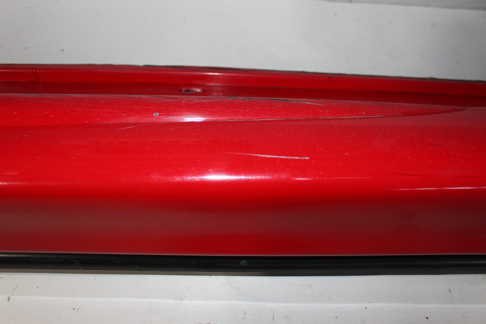 2006 Pontiac GTO LH Driver Rocker Molding Panel Red OEM - Day's Parts Yard